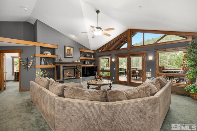 carpeted living room with ceiling fan, a fireplace, high vaulted ceiling, and french doors