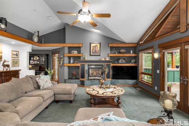 living room featuring ceiling fan, high vaulted ceiling, a fireplace, and carpet