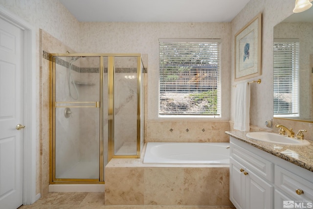 bathroom featuring vanity and independent shower and bath