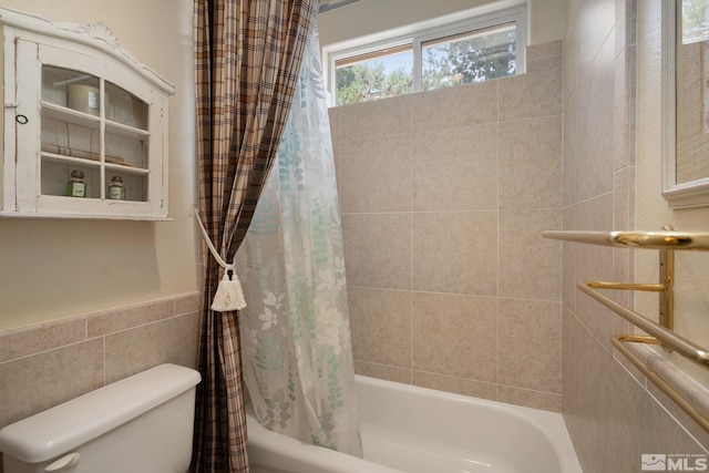 bathroom with shower / bath combo and toilet