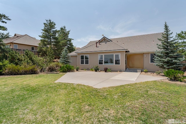 back of property featuring a yard and a patio