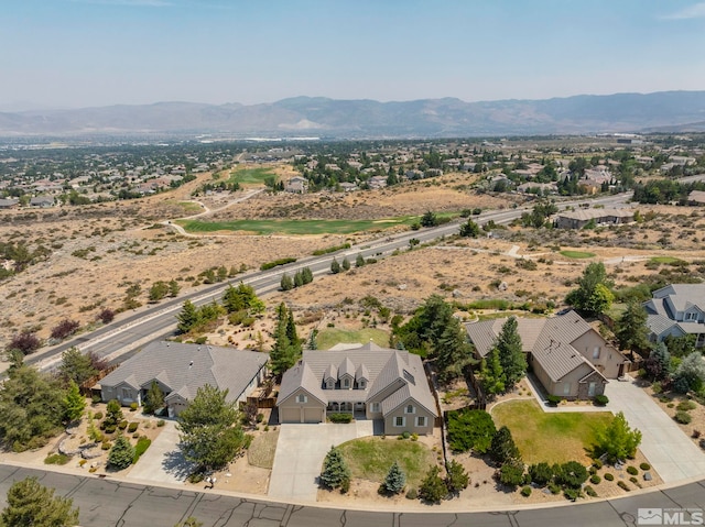 birds eye view of property with a mountain view