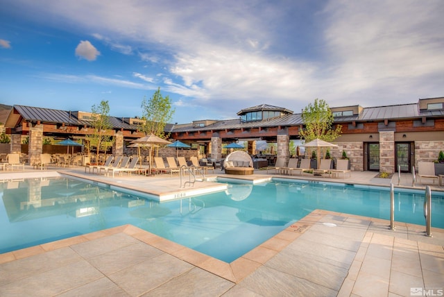 view of swimming pool featuring a patio area