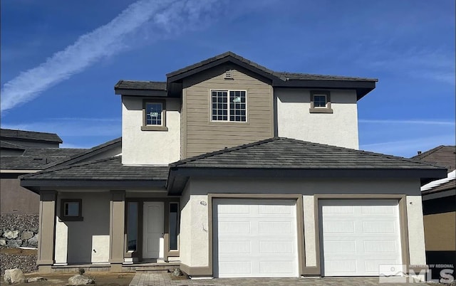 traditional-style home featuring stucco siding