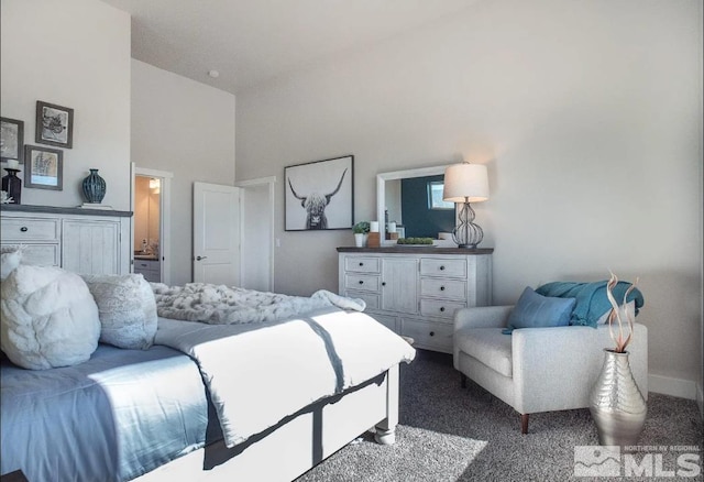 bedroom with dark colored carpet and a towering ceiling