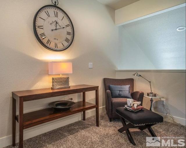 sitting room featuring carpet and baseboards