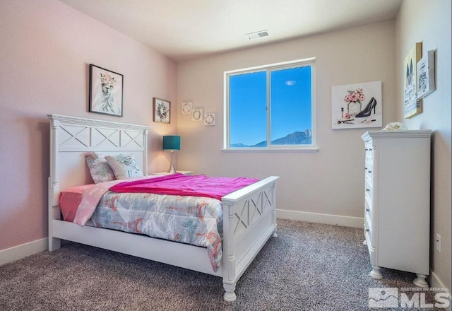 carpeted bedroom featuring visible vents and baseboards