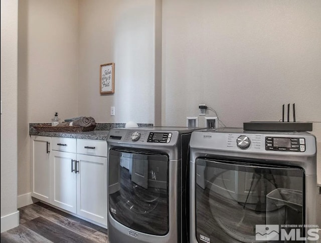 clothes washing area featuring cabinet space, baseboards, washer and clothes dryer, and dark wood-type flooring