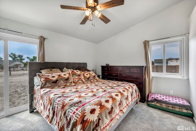 bedroom featuring access to exterior, lofted ceiling, light carpet, and a ceiling fan