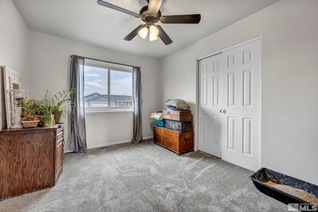 bedroom with ceiling fan, a closet, and light colored carpet