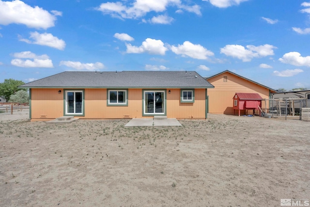 rear view of property featuring a patio area and fence