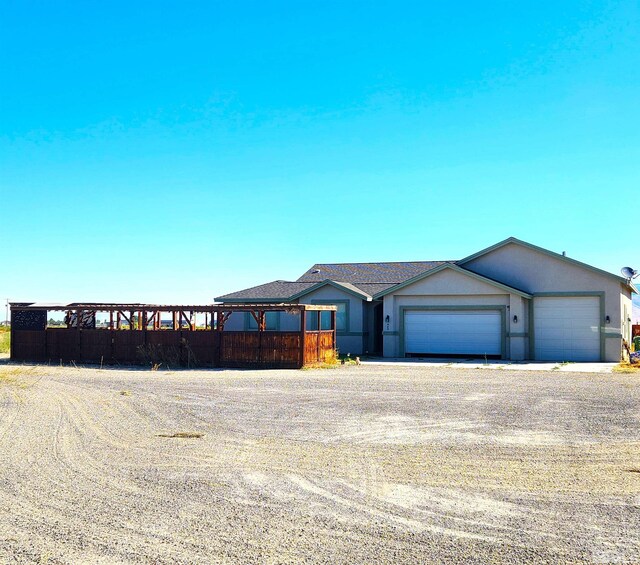 view of front facade featuring an attached garage, driveway, and stucco siding