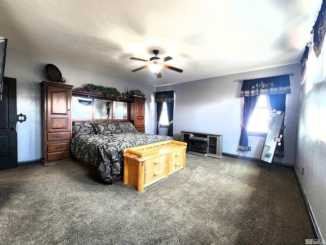 carpeted bedroom with a ceiling fan and baseboards