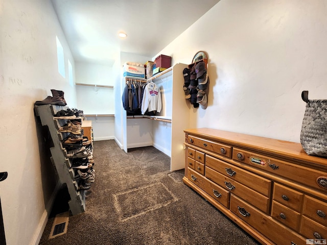 spacious closet with dark carpet