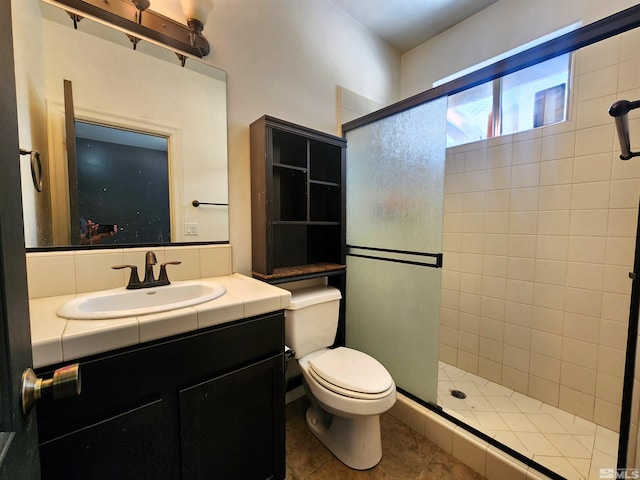 bathroom featuring toilet, a shower stall, tile patterned flooring, and vanity