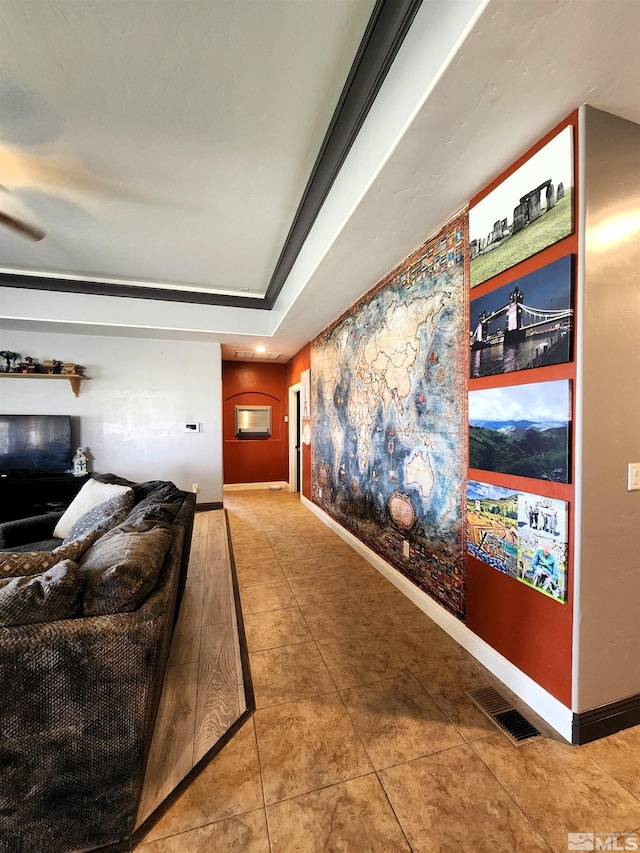 interior space featuring tile patterned flooring, visible vents, and baseboards