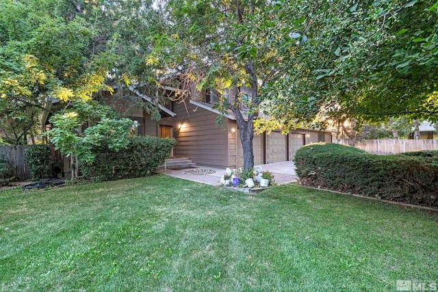 view of yard with a garage and fence