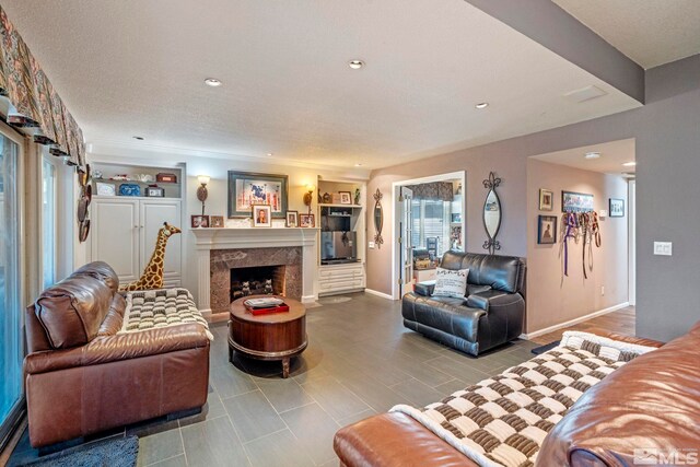 living room featuring a textured ceiling and a fireplace