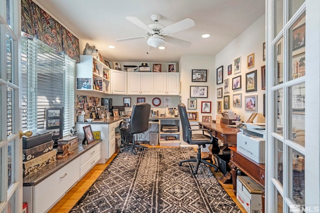 home office featuring light wood finished floors, built in study area, a ceiling fan, and recessed lighting