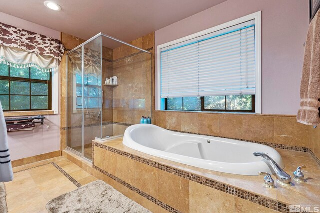 bathroom featuring separate shower and tub and tile patterned flooring