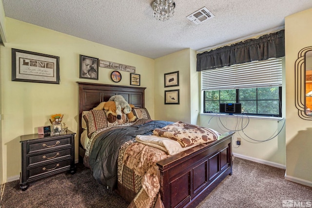 bedroom with baseboards, visible vents, dark colored carpet, and a textured ceiling