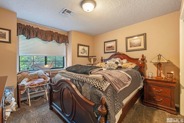 carpeted bedroom featuring a textured ceiling