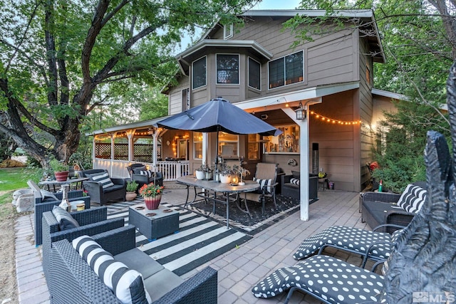 rear view of house with a wooden deck and an outdoor hangout area