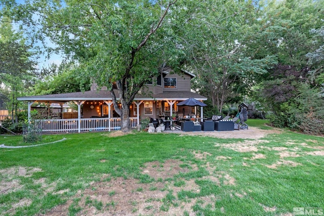 rear view of property with a patio area, a lawn, and an outdoor hangout area