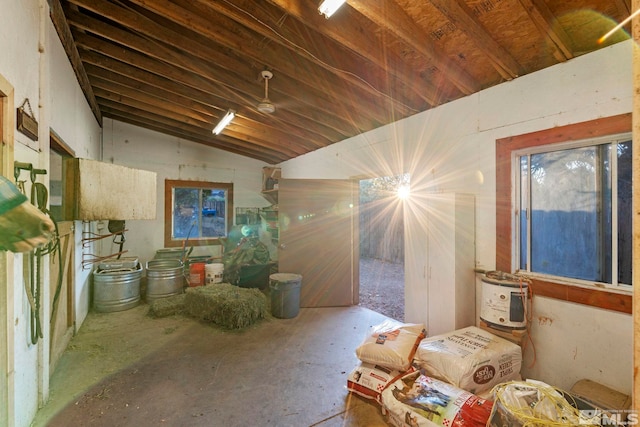 miscellaneous room with lofted ceiling and unfinished concrete floors