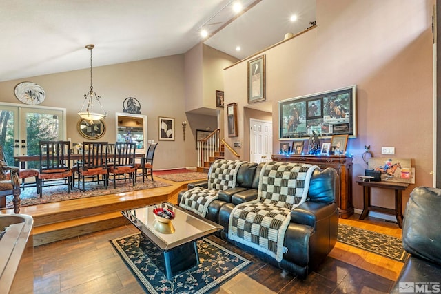 living room featuring high vaulted ceiling and french doors