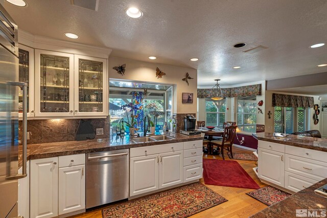 kitchen featuring sink, stainless steel appliances, light hardwood / wood-style flooring, and white cabinetry