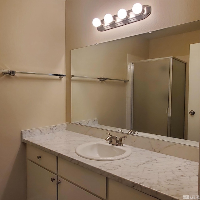 bathroom featuring an enclosed shower and vanity