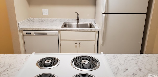 kitchen featuring white cabinetry, white appliances, and sink