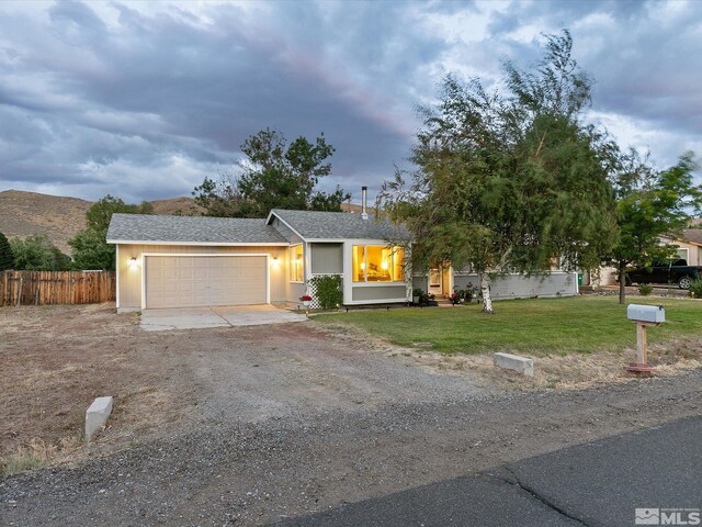 single story home featuring a yard and a garage