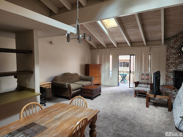 living room with light carpet, vaulted ceiling with skylight, a fireplace, and a chandelier