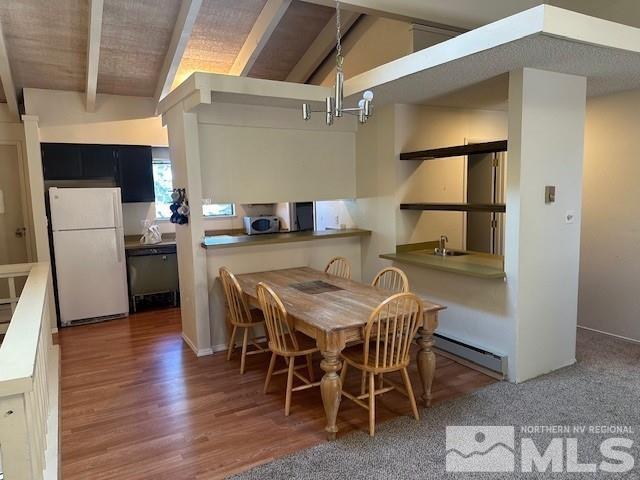 dining space with a baseboard radiator, wood finished floors, lofted ceiling with beams, and an inviting chandelier