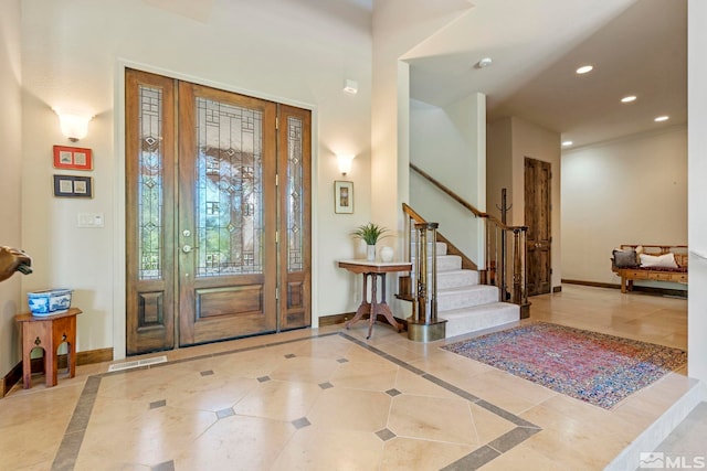 foyer entrance with light tile patterned flooring