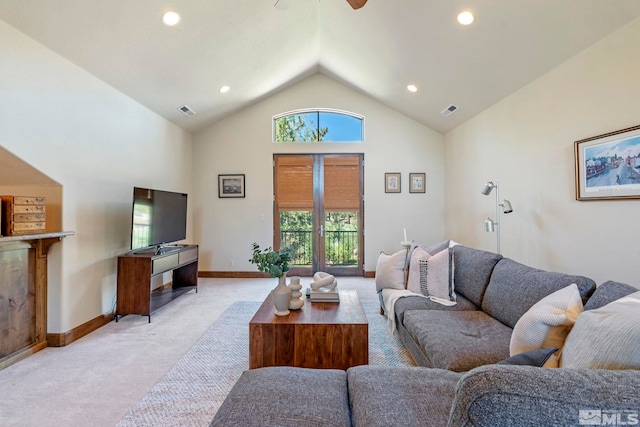 carpeted living room featuring ceiling fan and high vaulted ceiling