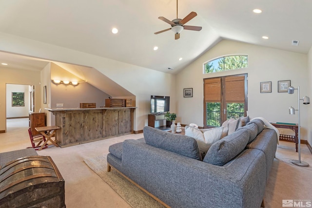 living room with high vaulted ceiling, ceiling fan, and light carpet