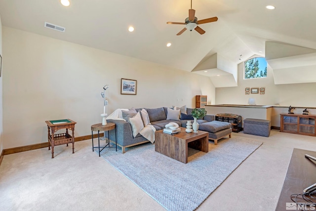 carpeted living room with ceiling fan and vaulted ceiling