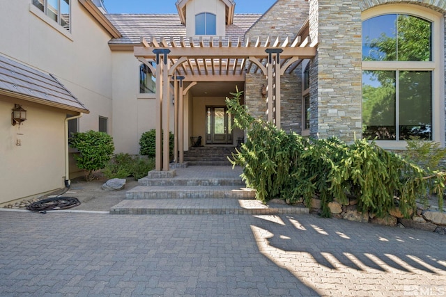 entrance to property with a pergola