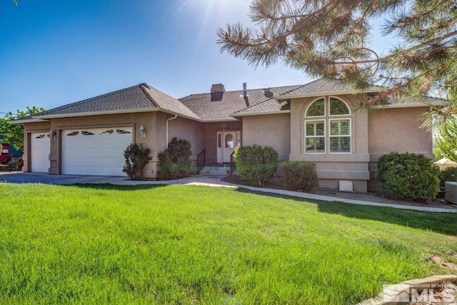 ranch-style house featuring a garage, a chimney, a front lawn, and stucco siding