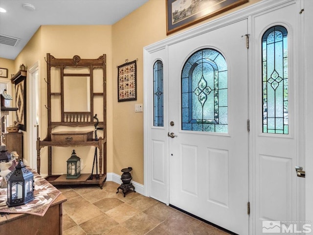 foyer entrance with plenty of natural light, visible vents, and baseboards