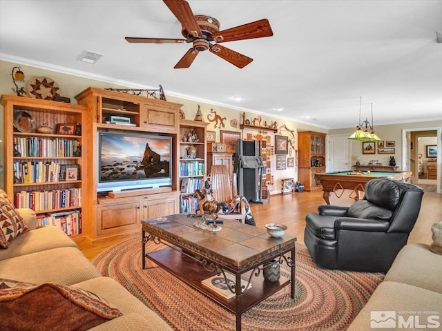 living area featuring light wood-style floors, pool table, crown molding, and visible vents