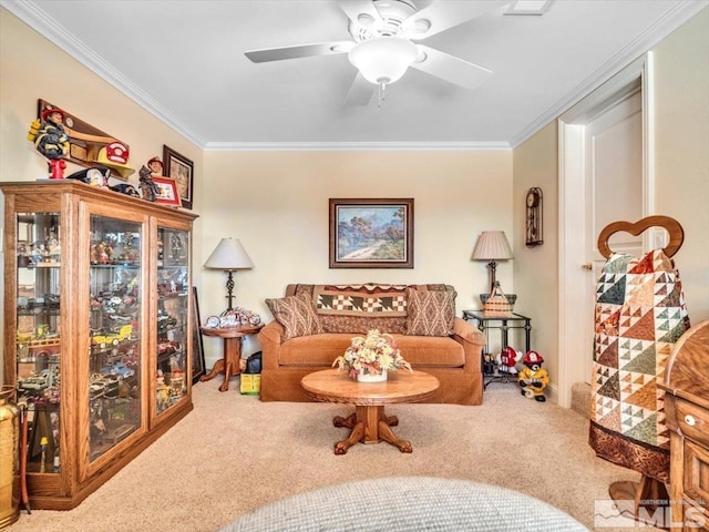 sitting room with a ceiling fan, crown molding, and carpet flooring