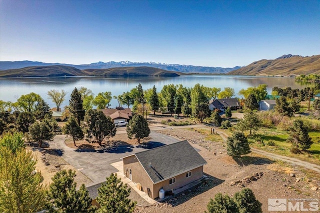 drone / aerial view with a water and mountain view