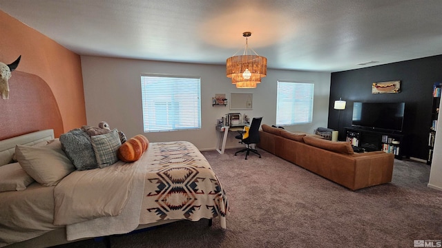 bedroom with a chandelier and carpet floors