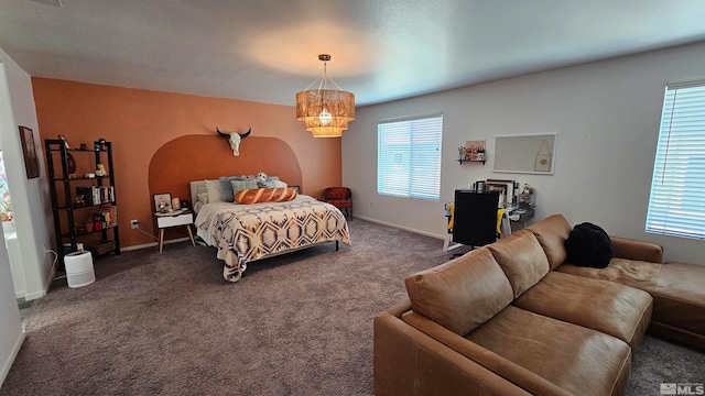 carpeted bedroom featuring a notable chandelier