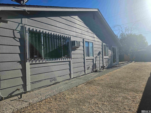 view of side of property with a wall unit AC