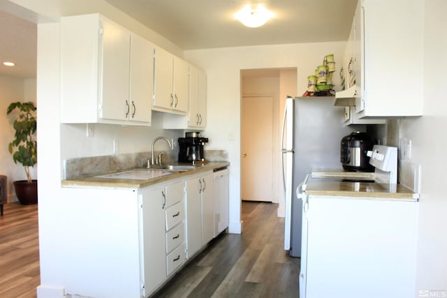 kitchen with white dishwasher, wood finished floors, a sink, white cabinetry, and light countertops